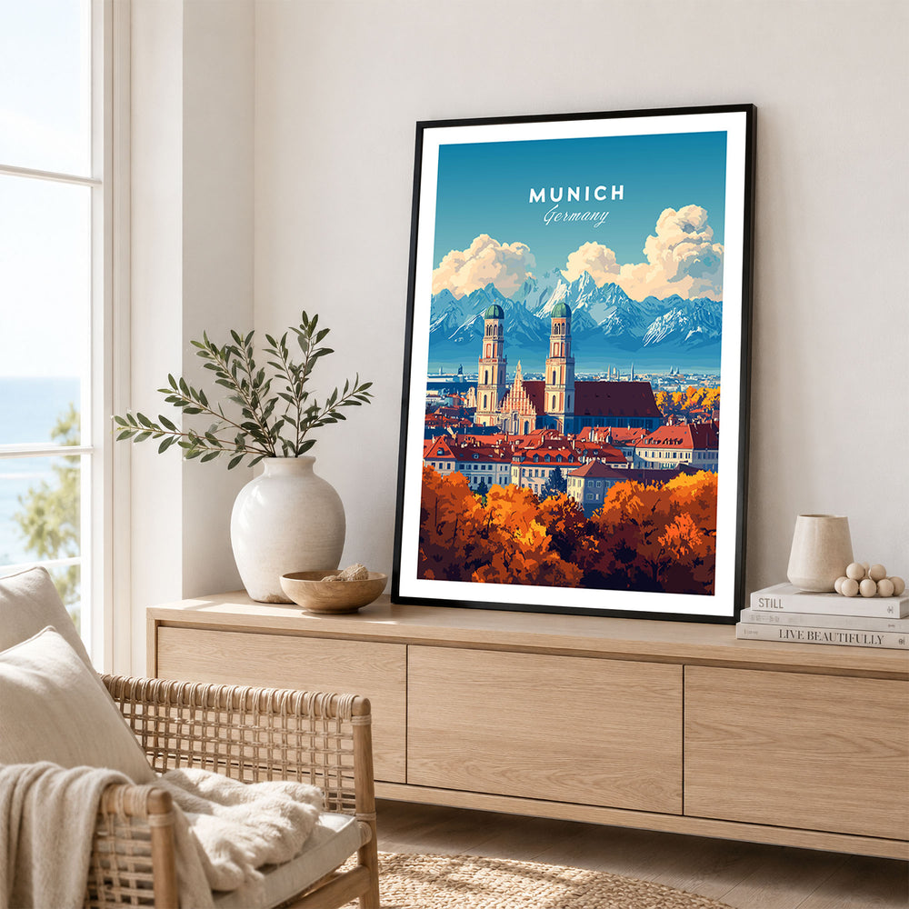 Munich Travel Print in a black frame displayed on an oak sideboard in a bright coastal living room