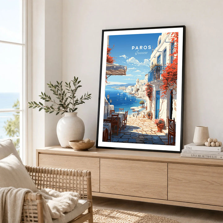 Paros Travel Poster in a black frame displayed on an oak sideboard in a bright coastal living room