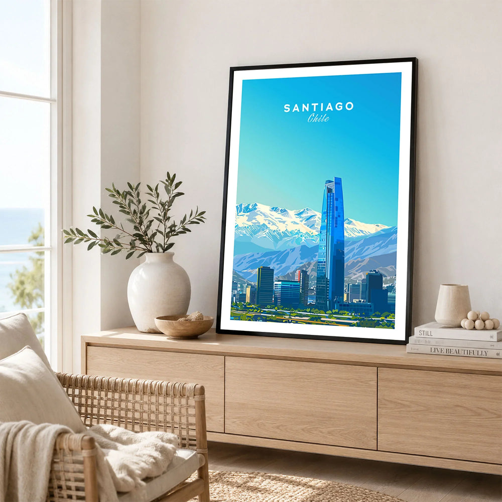 Santiago Travel Poster - Chile in a black frame displayed on an oak sideboard in a bright coastal living room