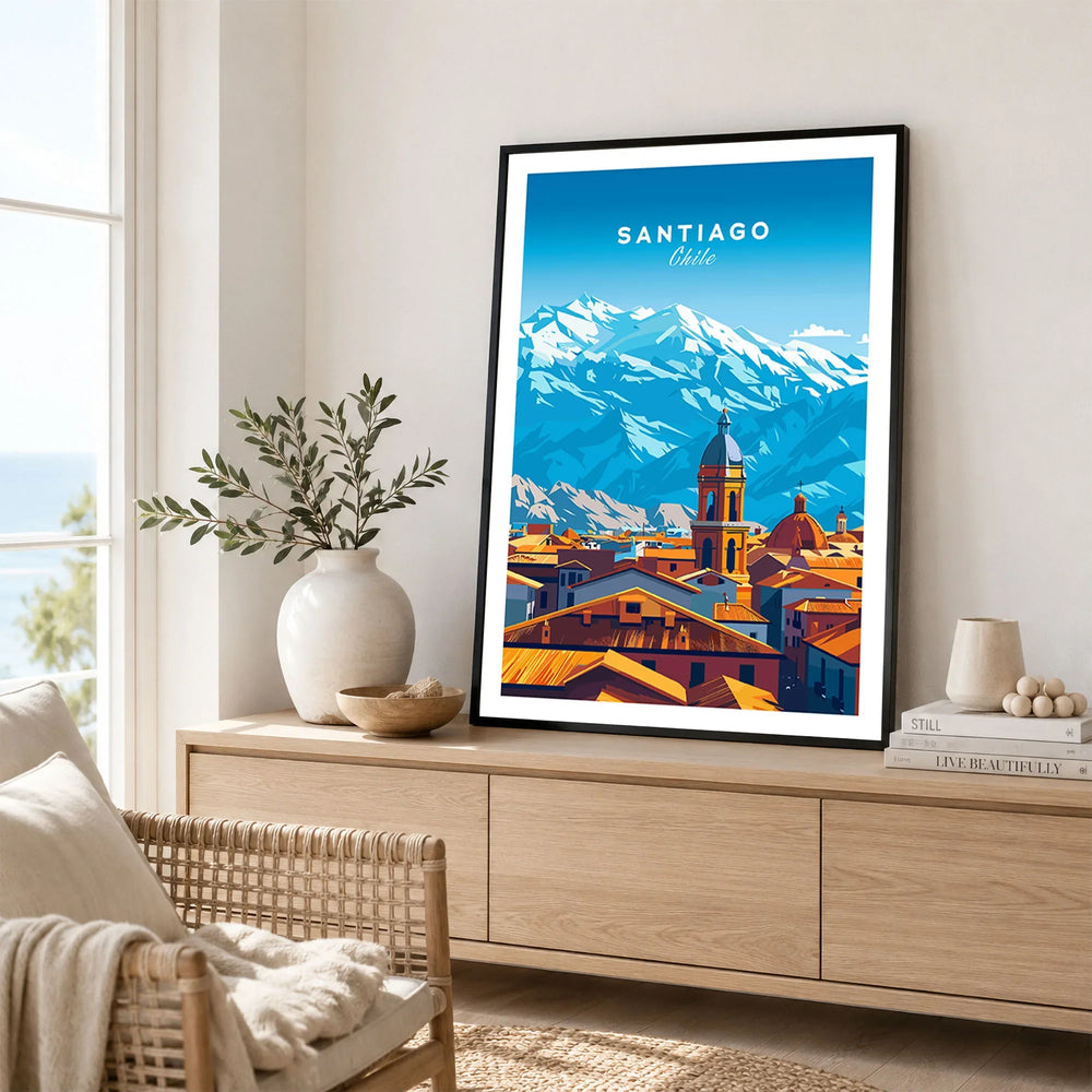 Santiago Travel Print - Chile Poster in a black frame displayed on an oak sideboard in a bright coastal living room