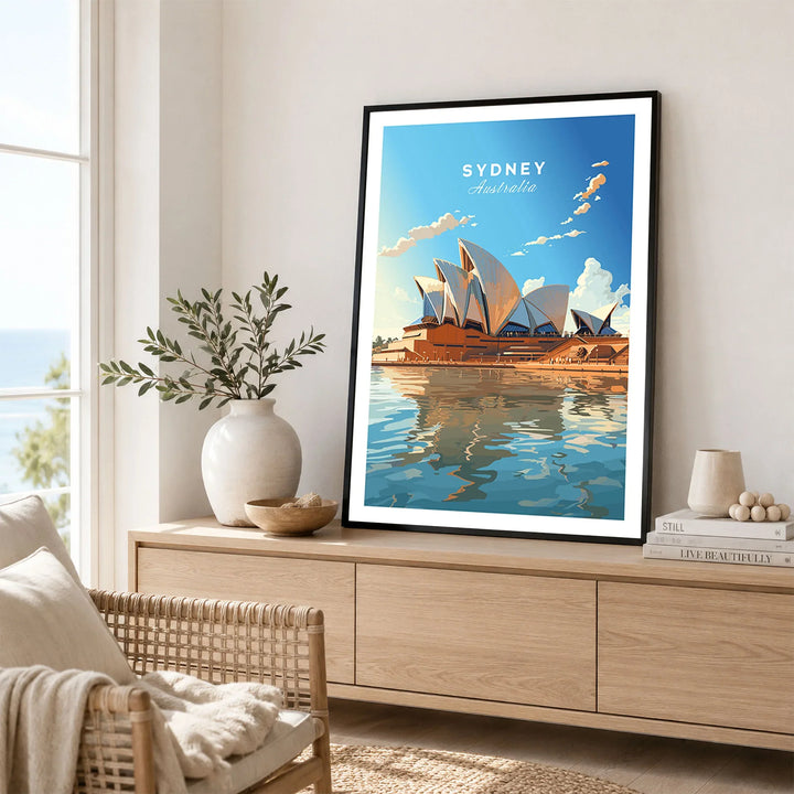 Sydney Poster Australia in a black frame displayed on an oak sideboard in a bright coastal living room