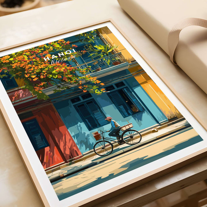 Vibrant Hanoi wall art print featuring a cyclist beside colorful buildings, capturing the energy of Vietnam's capital.