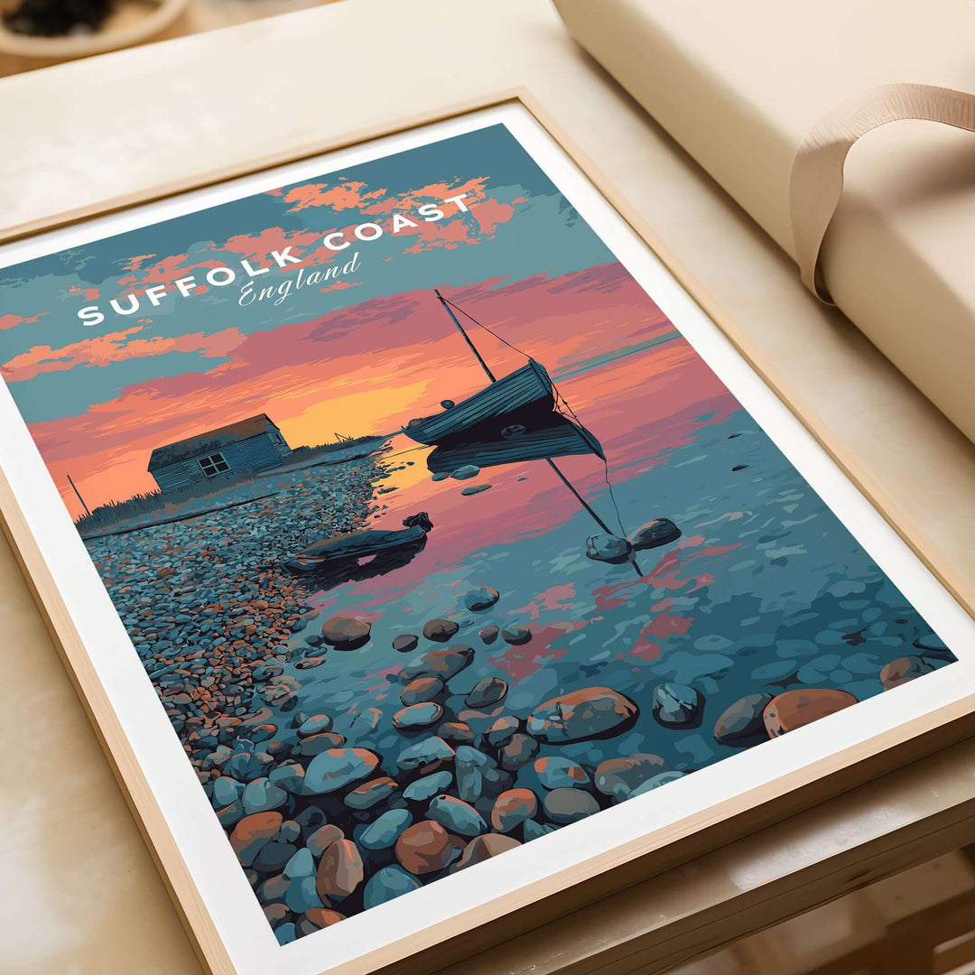 Suffolk Coast print featuring a sunset over a pebble beach with a boat and coastal hut, perfect for home decor.