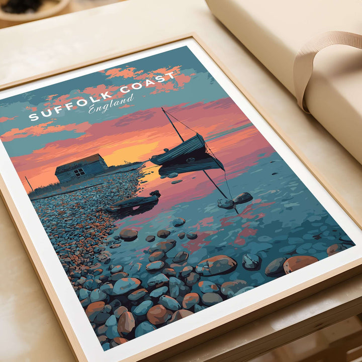 Suffolk Coast print featuring a sunset over a pebble beach with a boat and coastal hut, perfect for home decor.