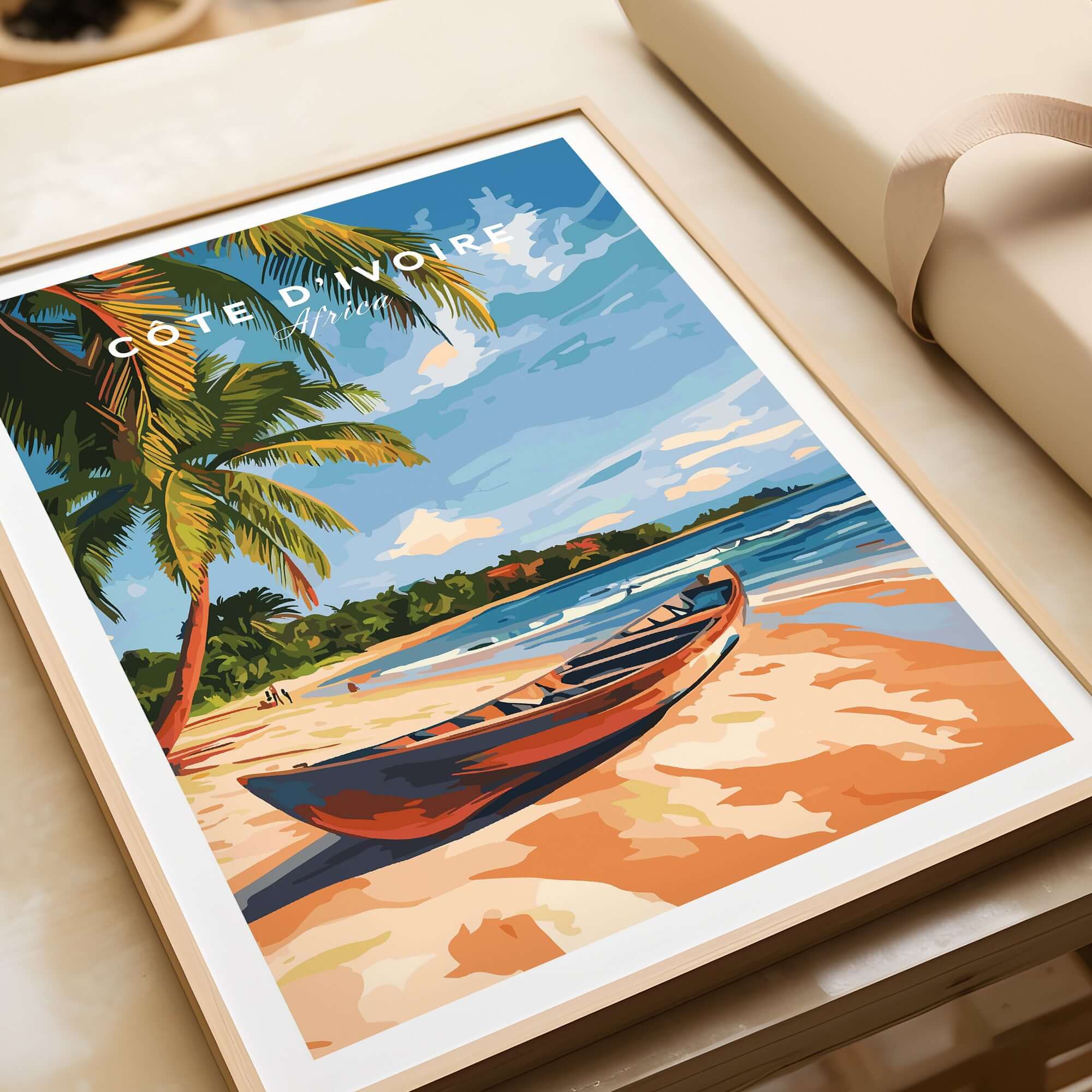 Côte d'Ivoire Beach Wall Art featuring a serene beach scene with palm trees and a canoe on sandy shores.
