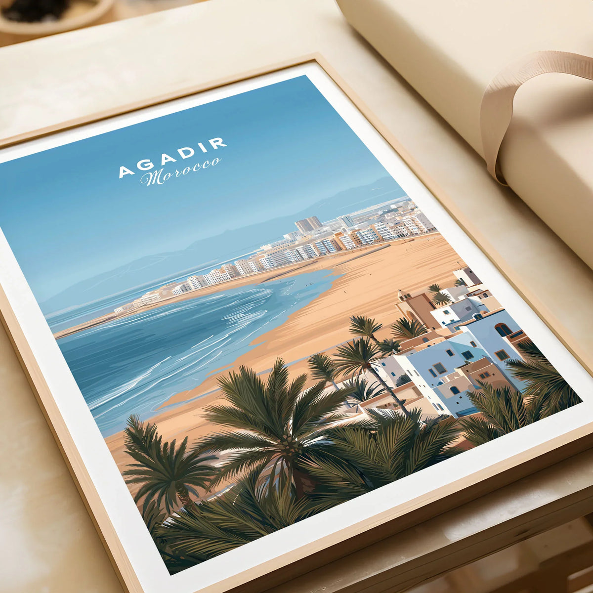 Agadir Morocco Poster – Travel Print in a natural wood frame beside wrapped gift packaging, close-up detail