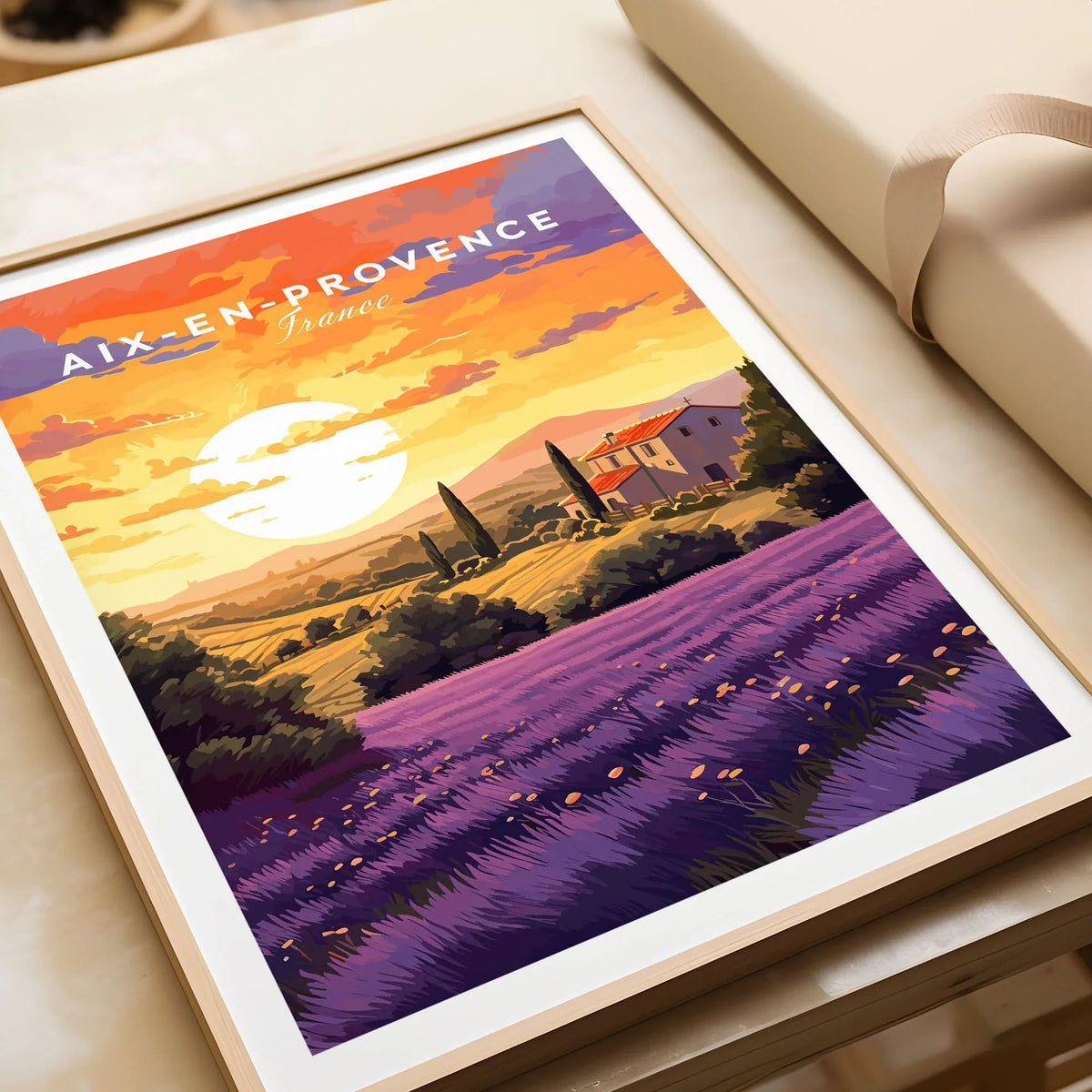 Aix-en-Provence Print in a natural wood frame beside wrapped gift packaging, close-up detail