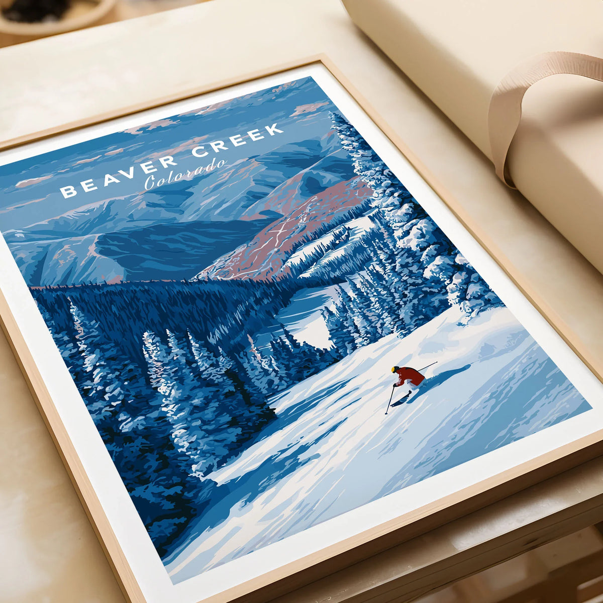 Beaver Creek Colorado Solo Skier Wall Art - Mountain Adventure Print in a natural wood frame beside wrapped gift packaging, close-up detail