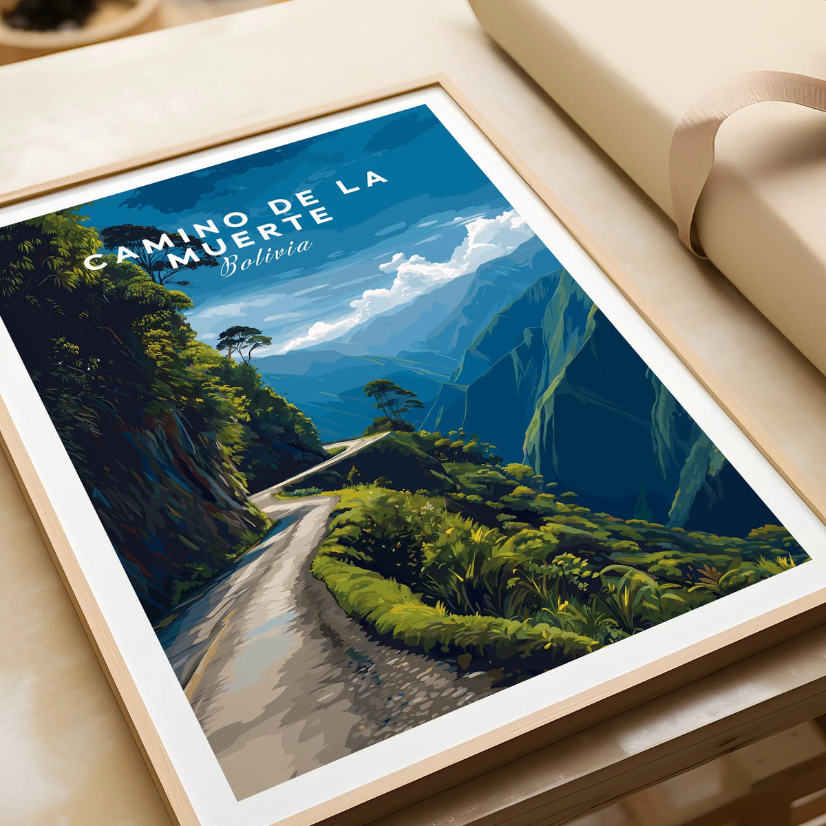 Camino de la Muerte Poster Bolivia Wall Art in a natural wood frame beside wrapped gift packaging, close-up detail