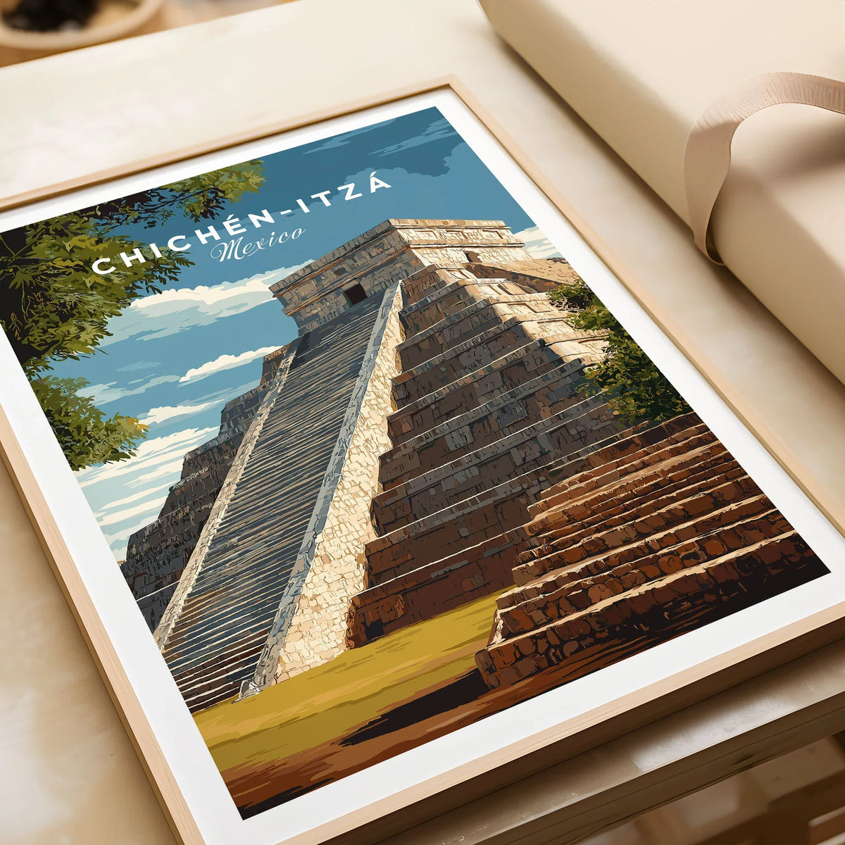 Chichén Itzá Mexico Travel Print El Castillo Pyramid Poster Mayan Ruins Wall Art in a natural wood frame beside wrapped gift packaging, close-up detail