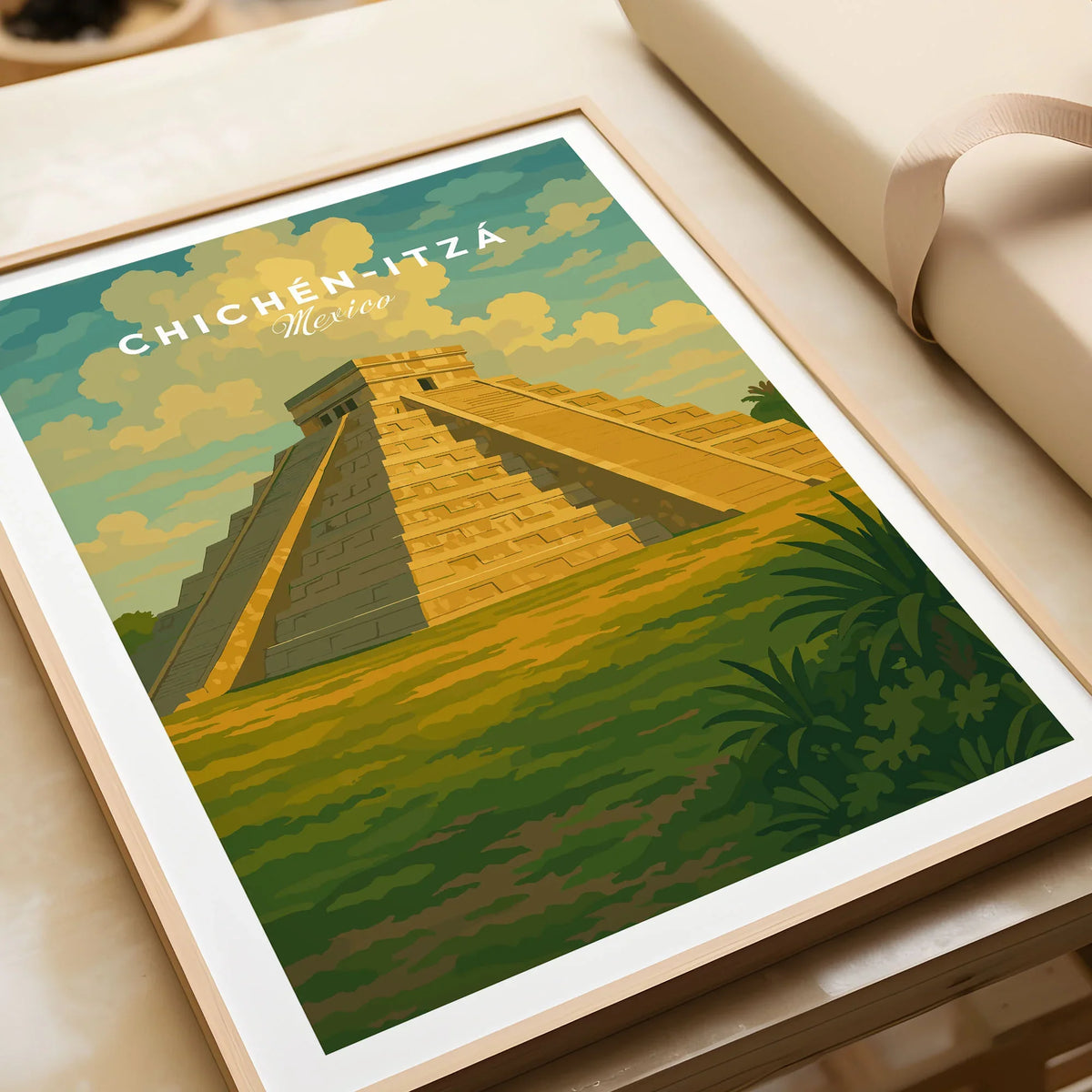 Chichén Itzá Mexico El Castillo Pyramid Travel Print Mayan Landscape Poster Wall Art in a natural wood frame beside wrapped gift packaging, close-up detail