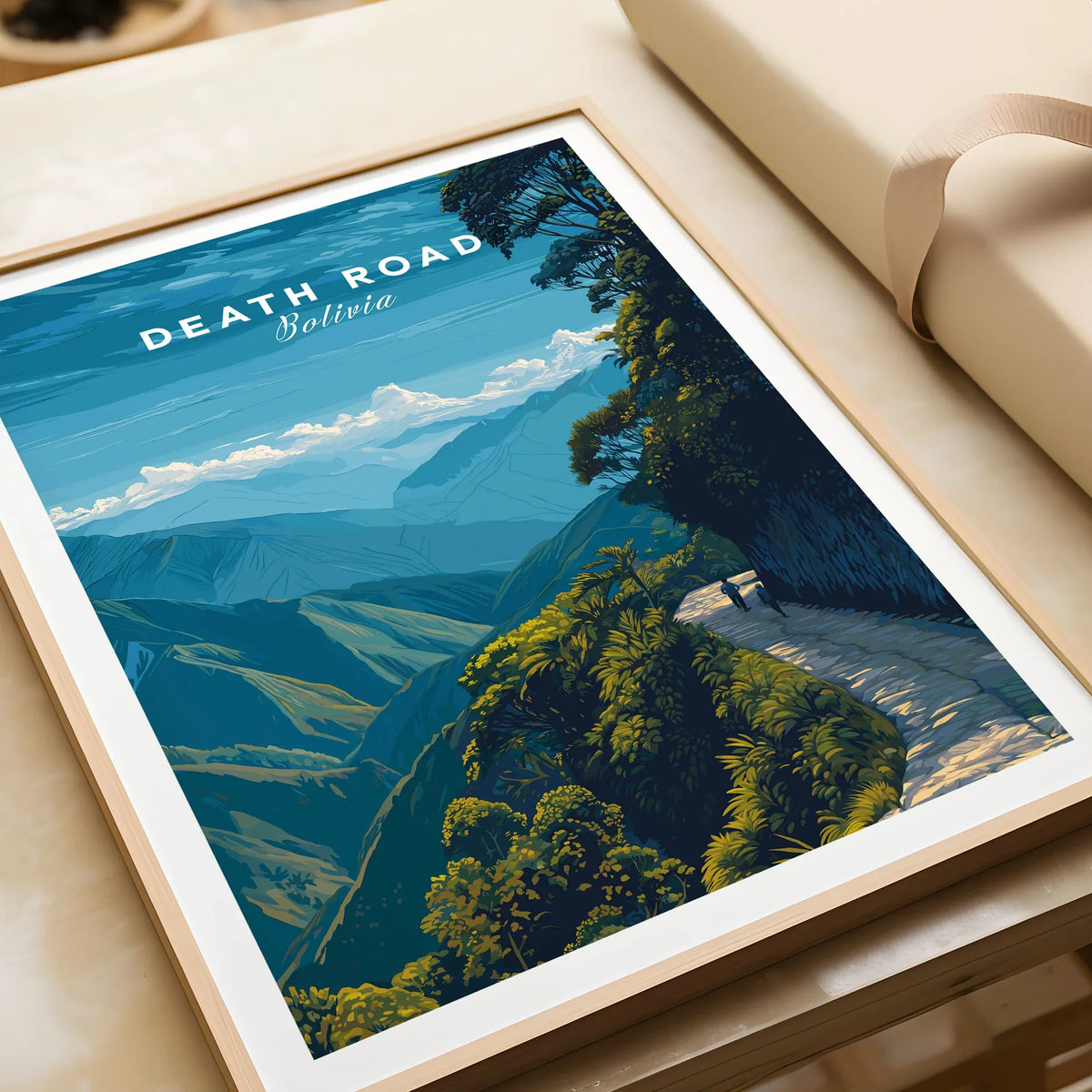 Death Road Yungas Adventure Scenic Print | Bolivian Travel Wall Decor in a natural wood frame beside wrapped gift packaging, close-up detail