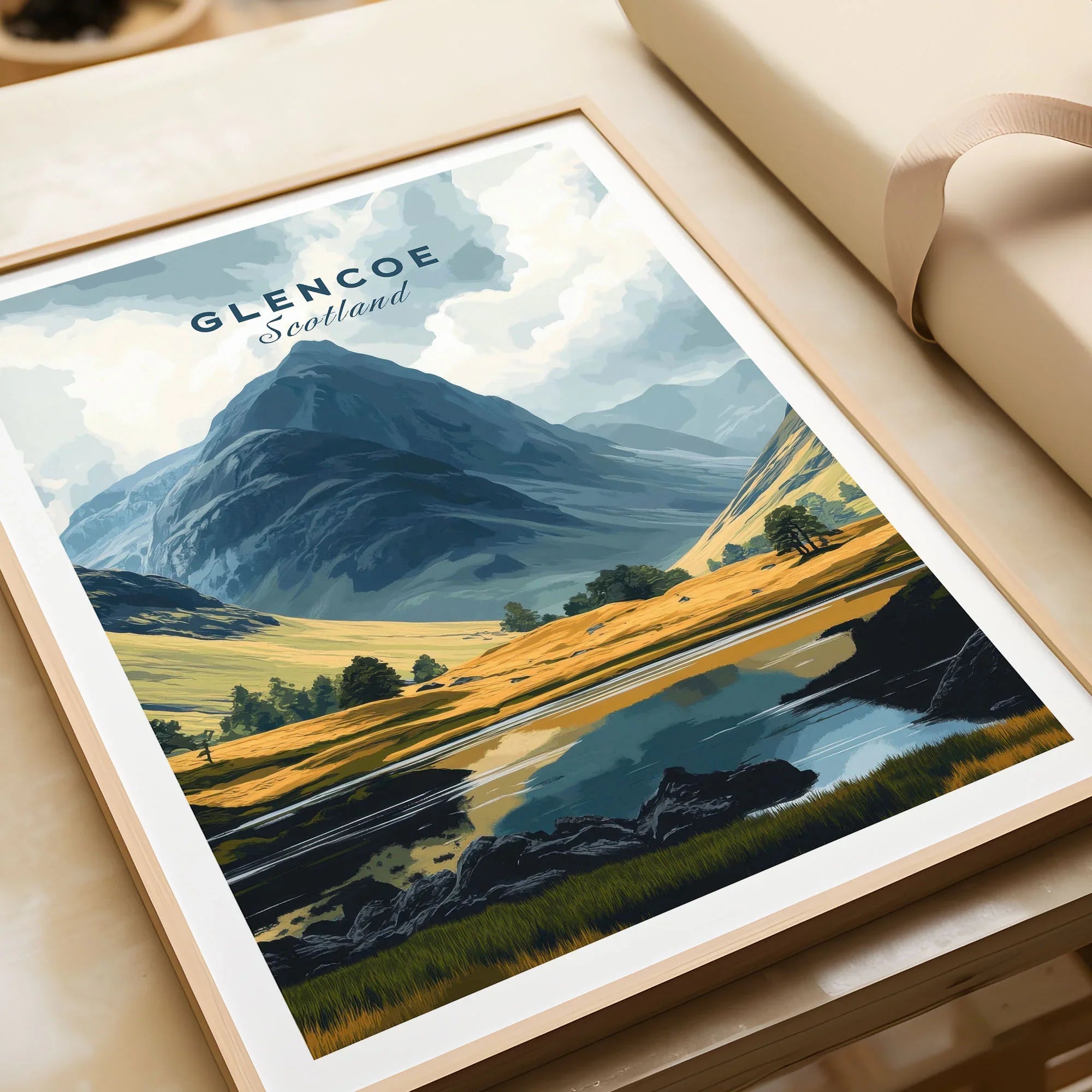 Glencoe Travel Print in a natural wood frame beside wrapped gift packaging, close-up detail