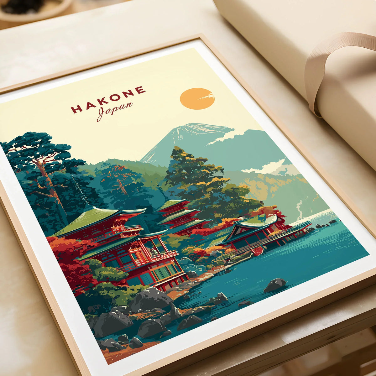 Hakone Japan Lake Ashi Temple Print - Japanese Pagoda Wall Art in a natural wood frame beside wrapped gift packaging, close-up detail