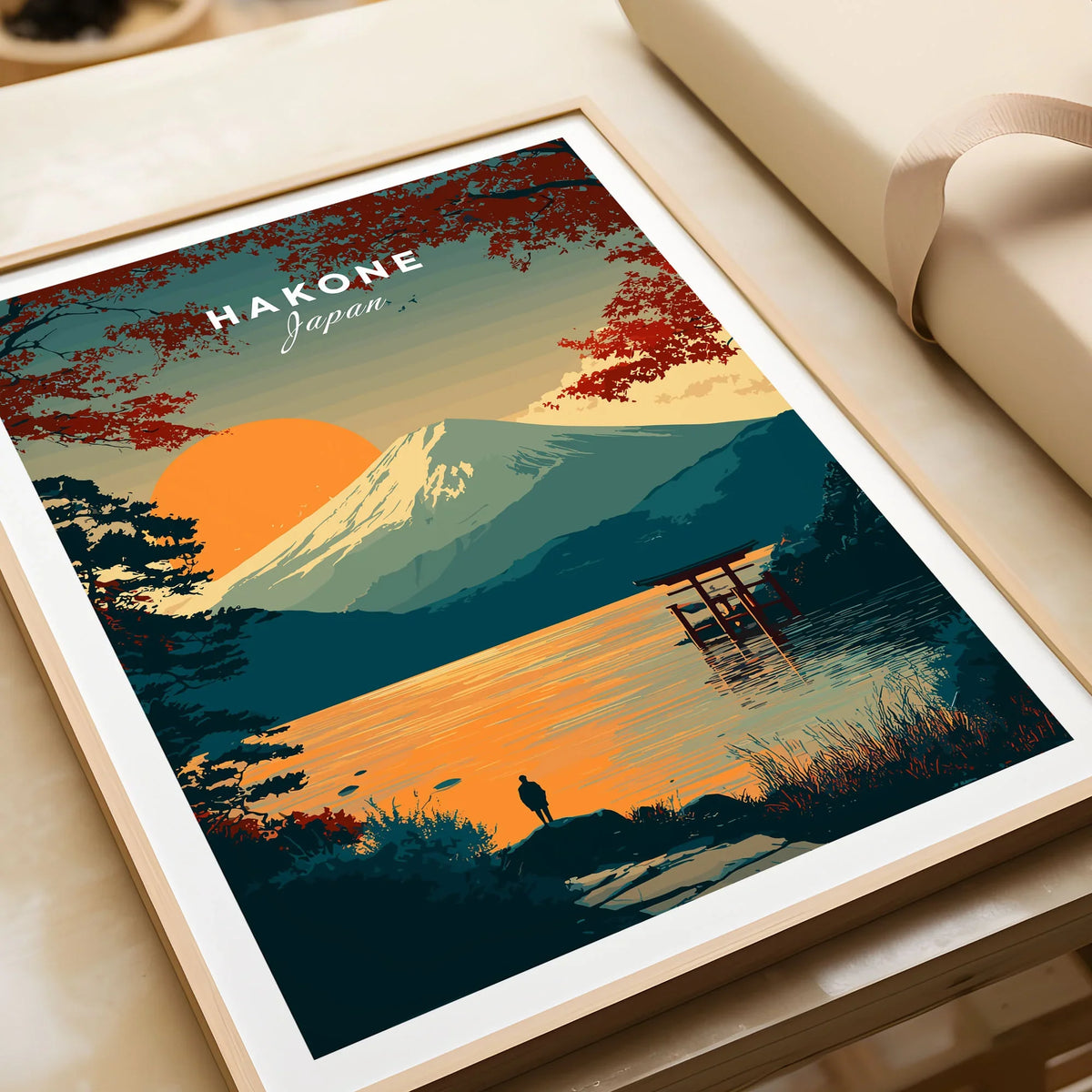 Hakone Japan Torii Gate Sunset Poster - Mount Fuji Lake Scene Print in a natural wood frame beside wrapped gift packaging, close-up detail