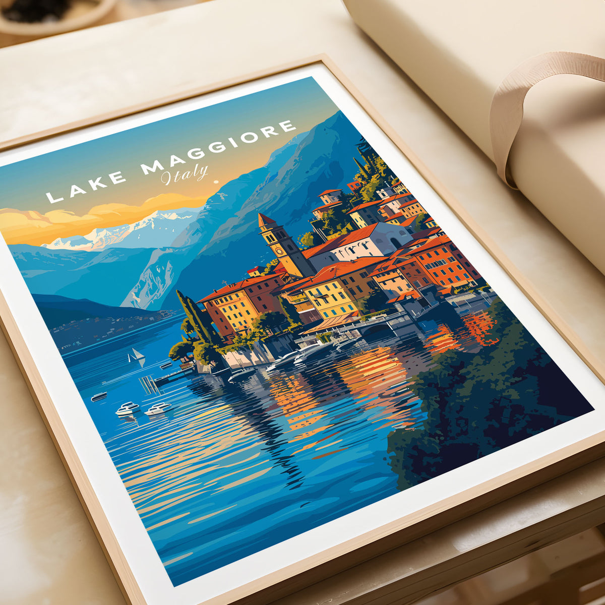 Lake Maggiore Print in a natural wood frame beside wrapped gift packaging, close-up detail