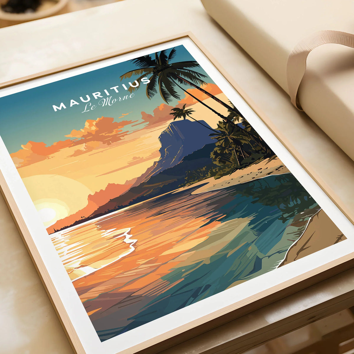 Le Morne Mauritius Poster in a natural wood frame beside wrapped gift packaging, close-up detail