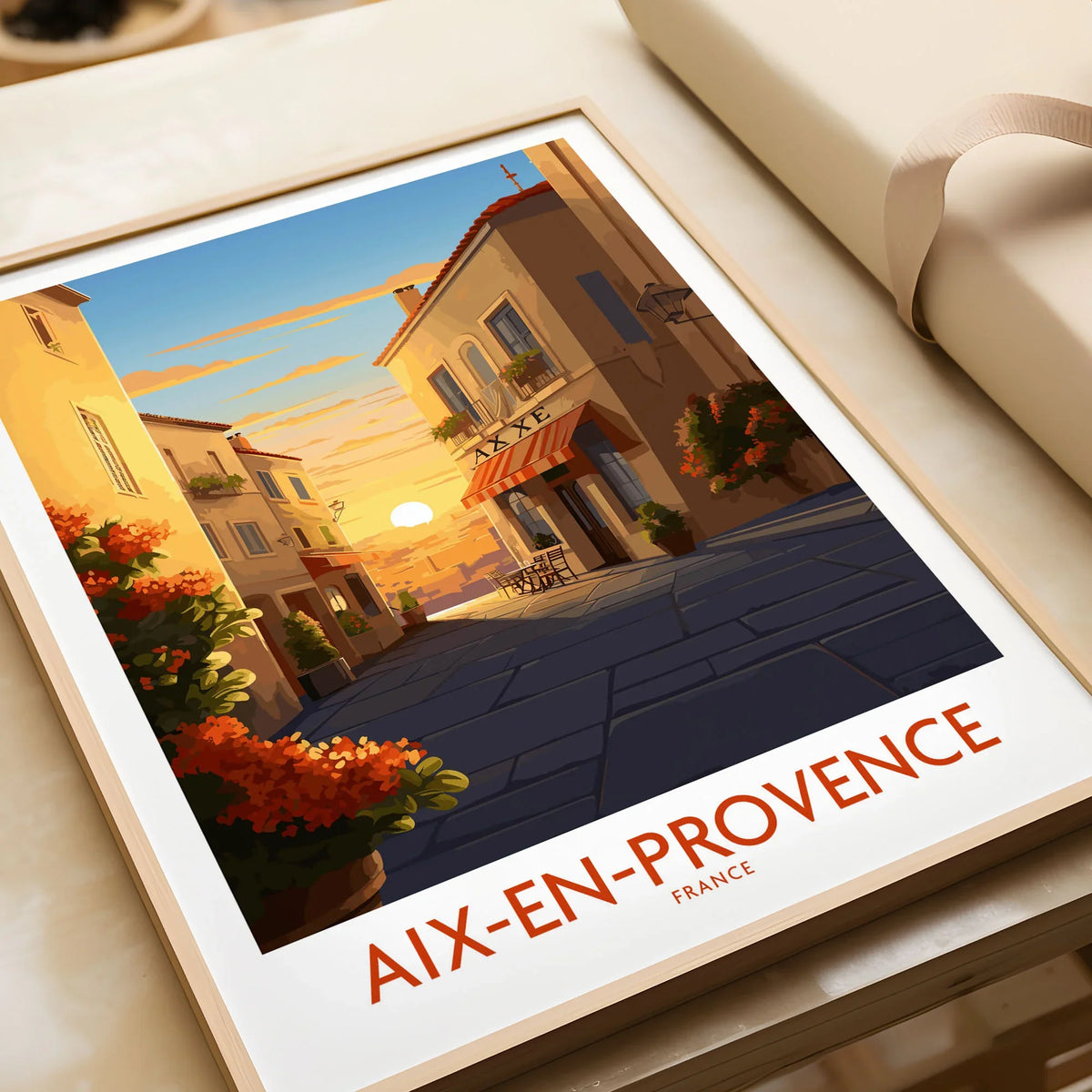 Aix-en-Provence Wall Art in a natural wood frame beside wrapped gift packaging, close-up detail