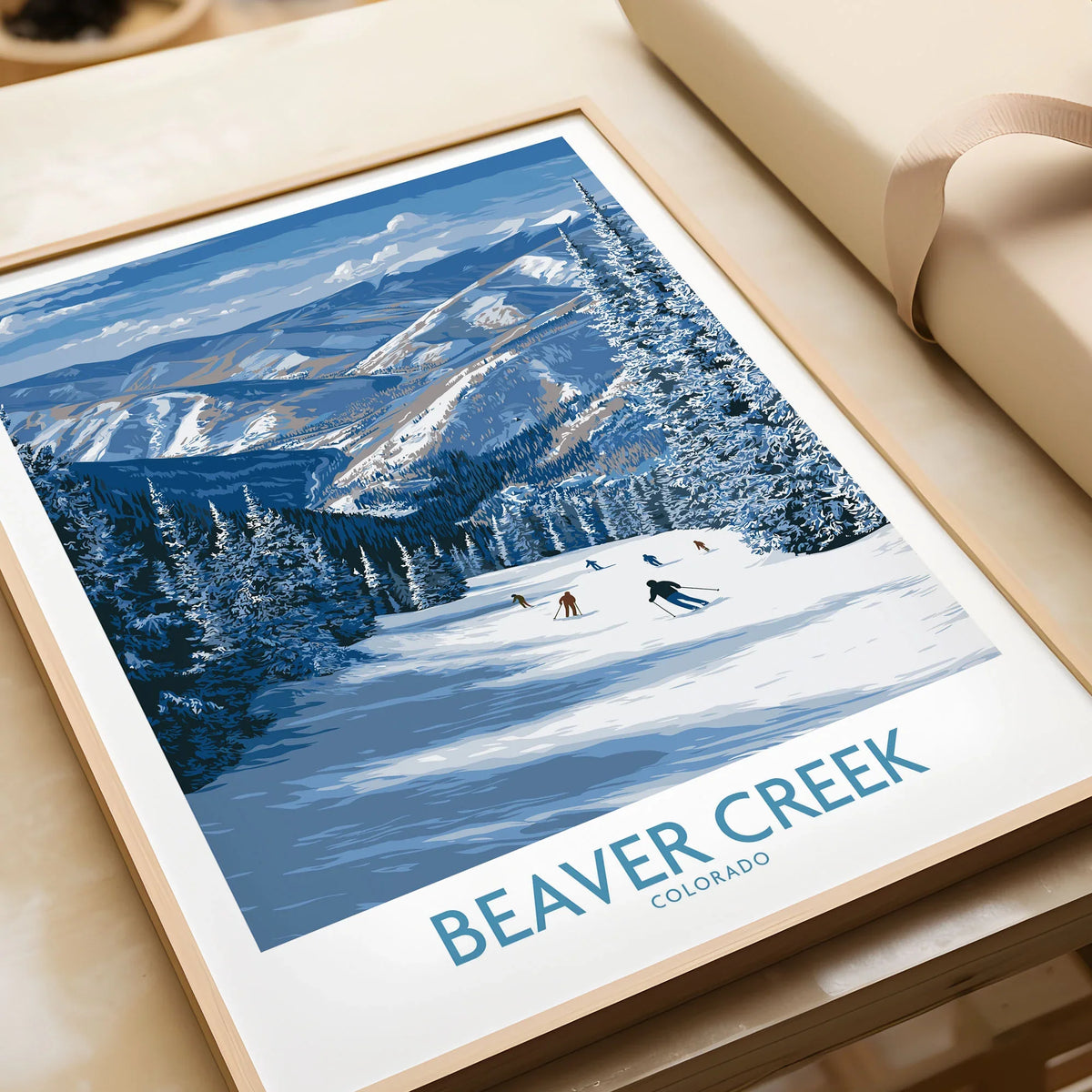 Beaver Creek Colorado Winter Wonderland Wall Art - Group Skiing Landscape in a natural wood frame beside wrapped gift packaging, close-up detail