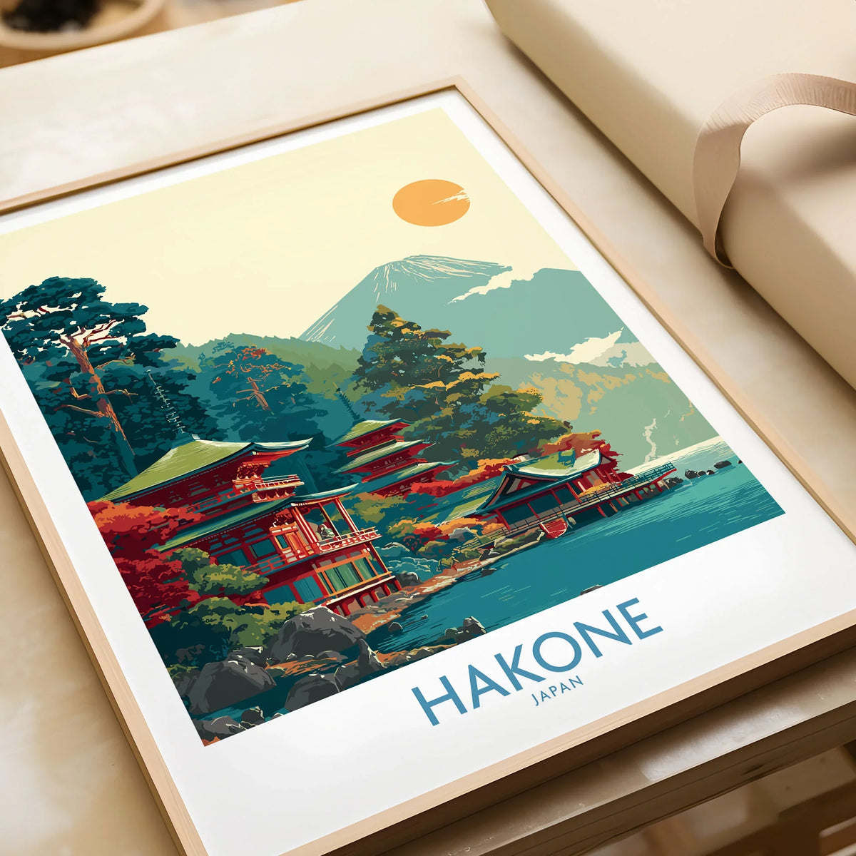 Hakone Japan Lake Ashi Temple Print - Japanese Pagoda Wall Art - Modern in a natural wood frame beside wrapped gift packaging, close-up detail