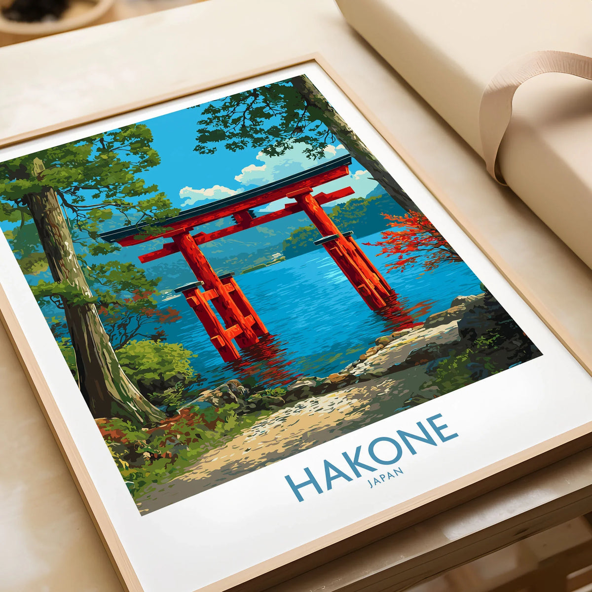 Hakone Japan Iconic Torii Print - Japanese Scenic Landscape Decor in a natural wood frame beside wrapped gift packaging, close-up detail