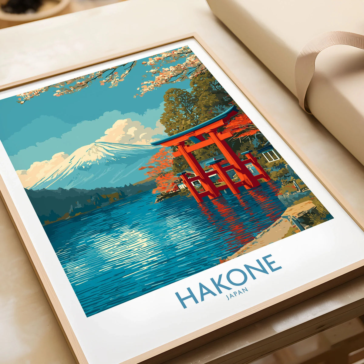 Hakone Wall Art Japan Red Torii Gate Poster in a natural wood frame beside wrapped gift packaging, close-up detail