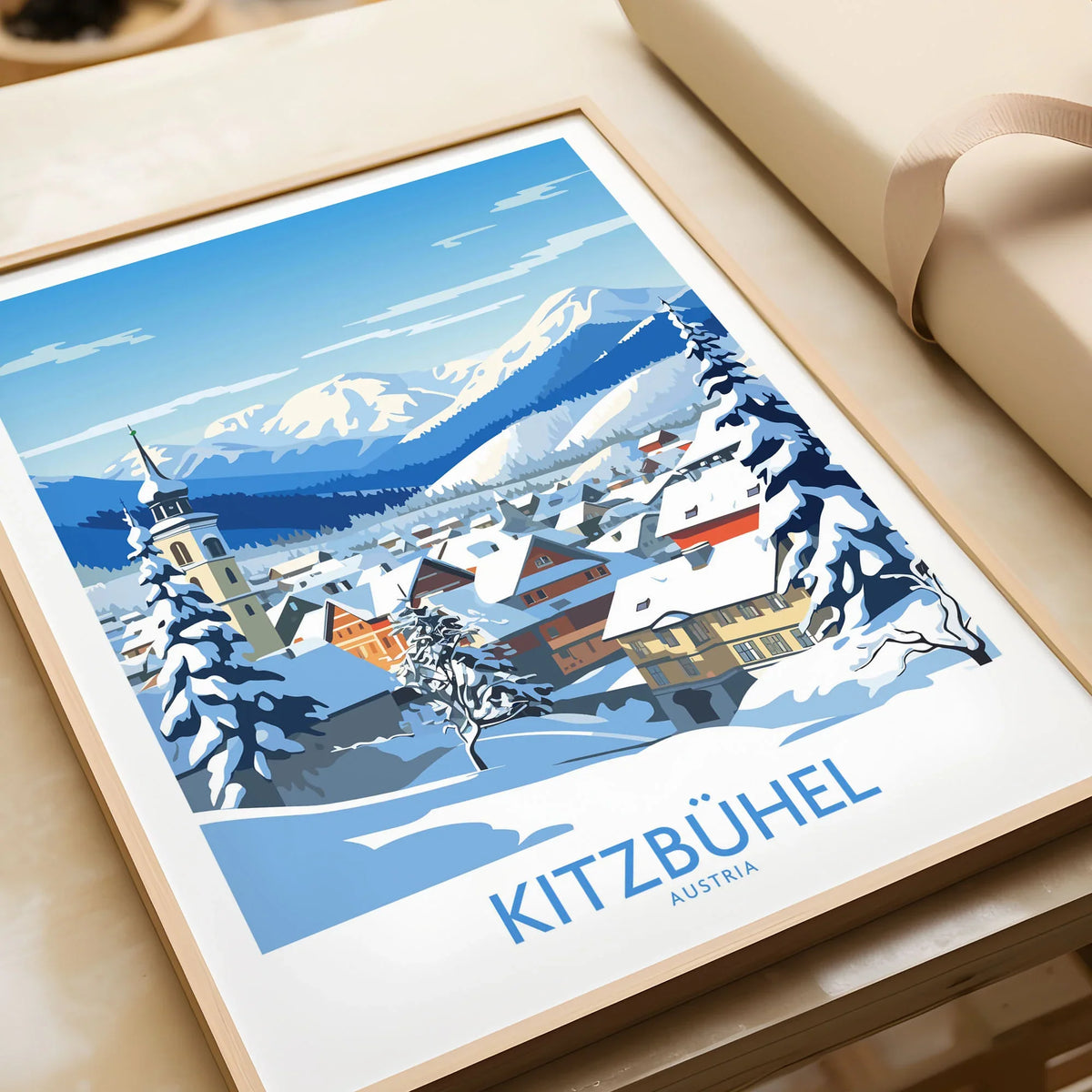 Kitzbuhel Austria Art Print in a natural wood frame beside wrapped gift packaging, close-up detail