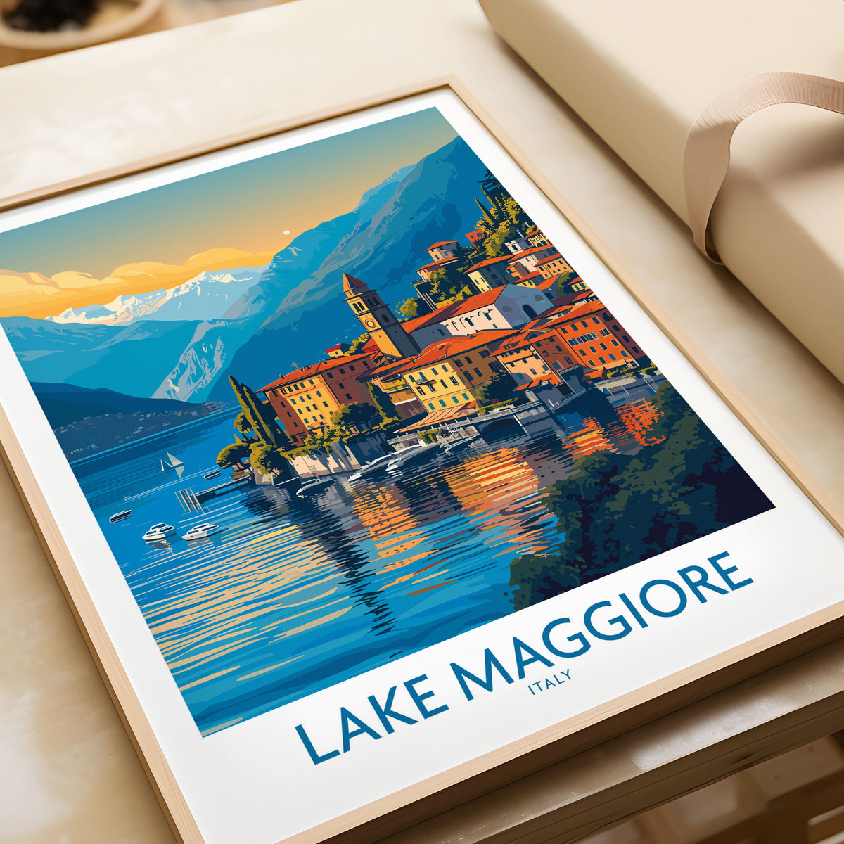 Lake Maggiore Italy Poster in a natural wood frame beside wrapped gift packaging, close-up detail
