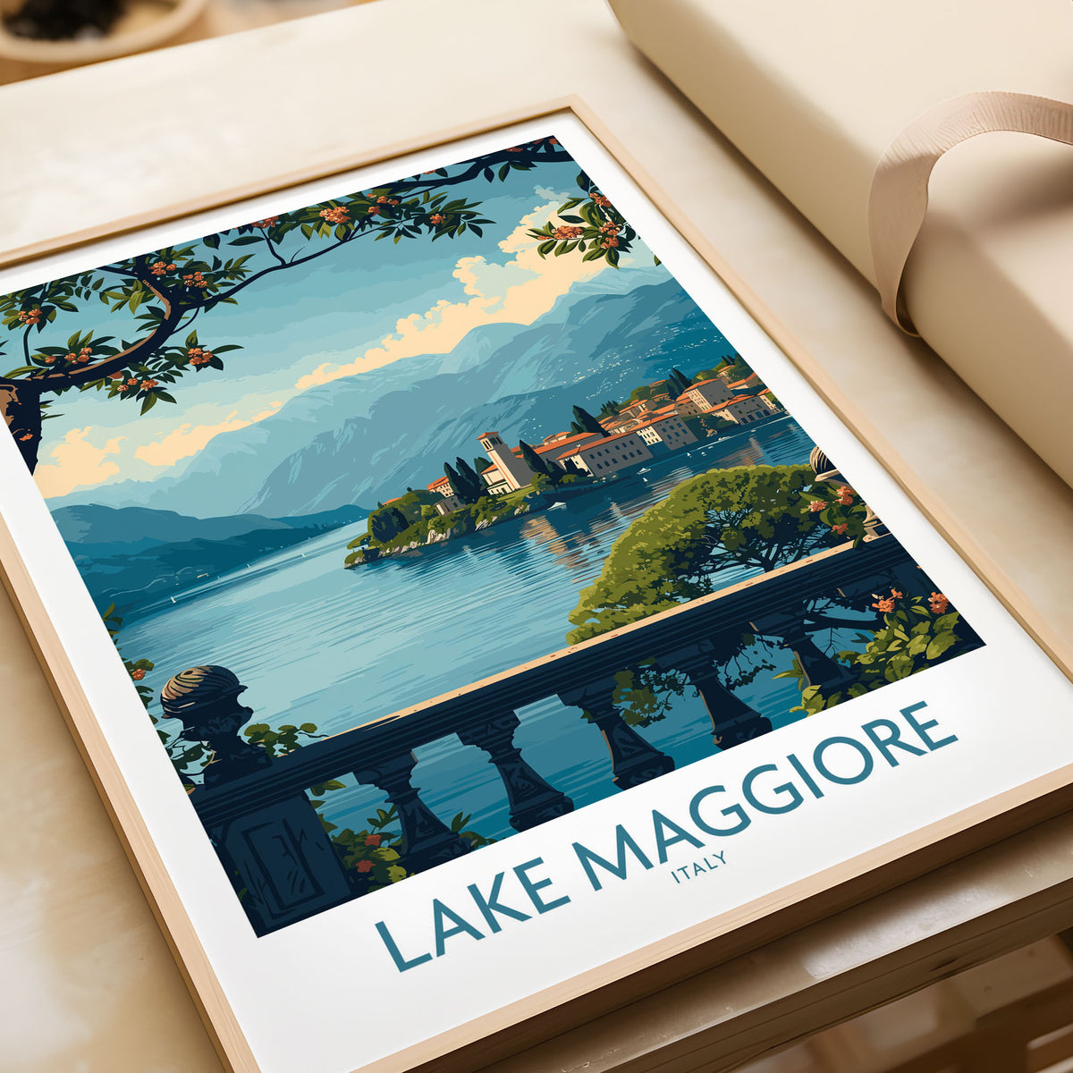 Lake Maggiore Poster Italy in a natural wood frame beside wrapped gift packaging, close-up detail