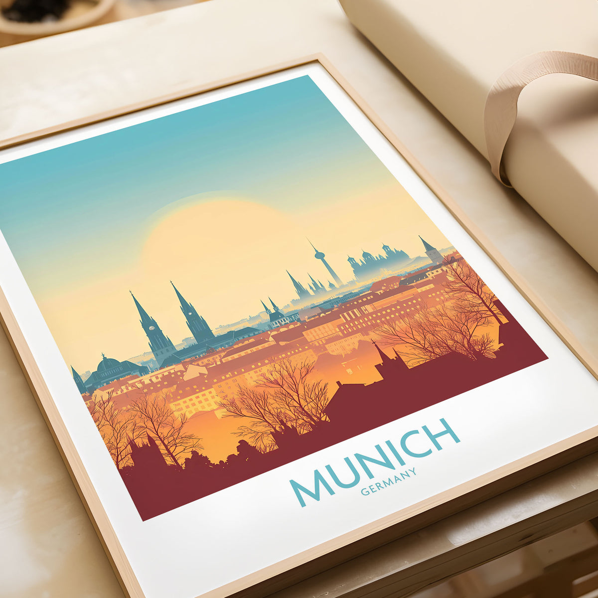 Munich Print Germany in a natural wood frame beside wrapped gift packaging, close-up detail