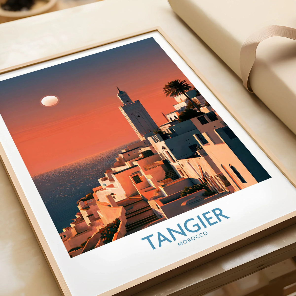 Tangier Morocco Coastal Sunset Wall Art — a whitewashed hillside town and minaret glowing above the sea at sunset, shown as framed art print closeup gift unwrapped natural frame