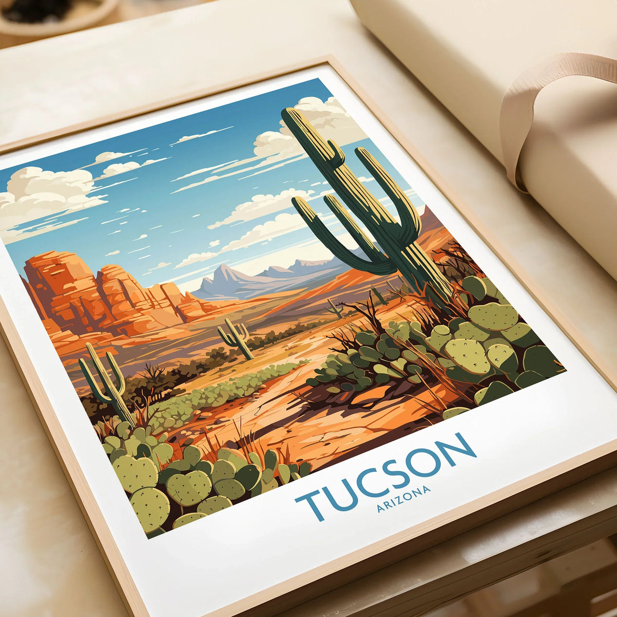 Tucson Arizona Wall Art in a natural wood frame beside wrapped gift packaging, close-up detail