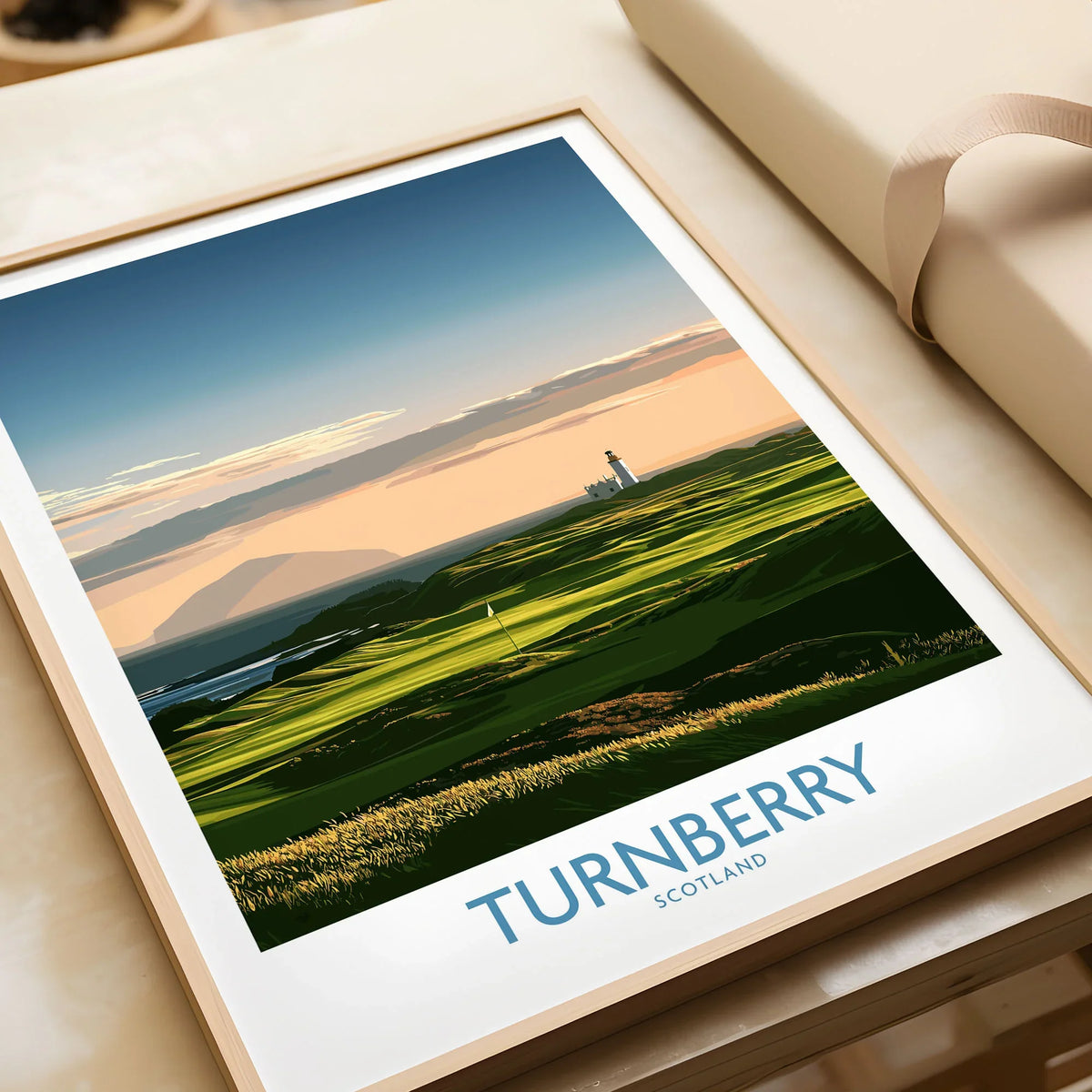 Turnberry Scotland Ayrshire Dusk Wall Art — Ailsa Craig and the white lighthouse across rolling coastal turf at dusk, shown as framed art print closeup gift unwrapped natural frame