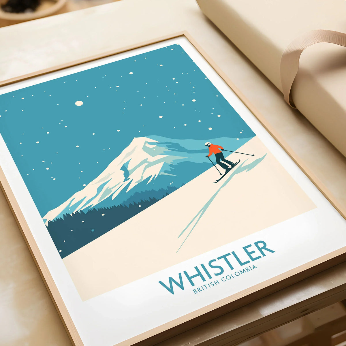 Whistler Wall Art Print -  British Columbia in a natural wood frame beside wrapped gift packaging, close-up detail