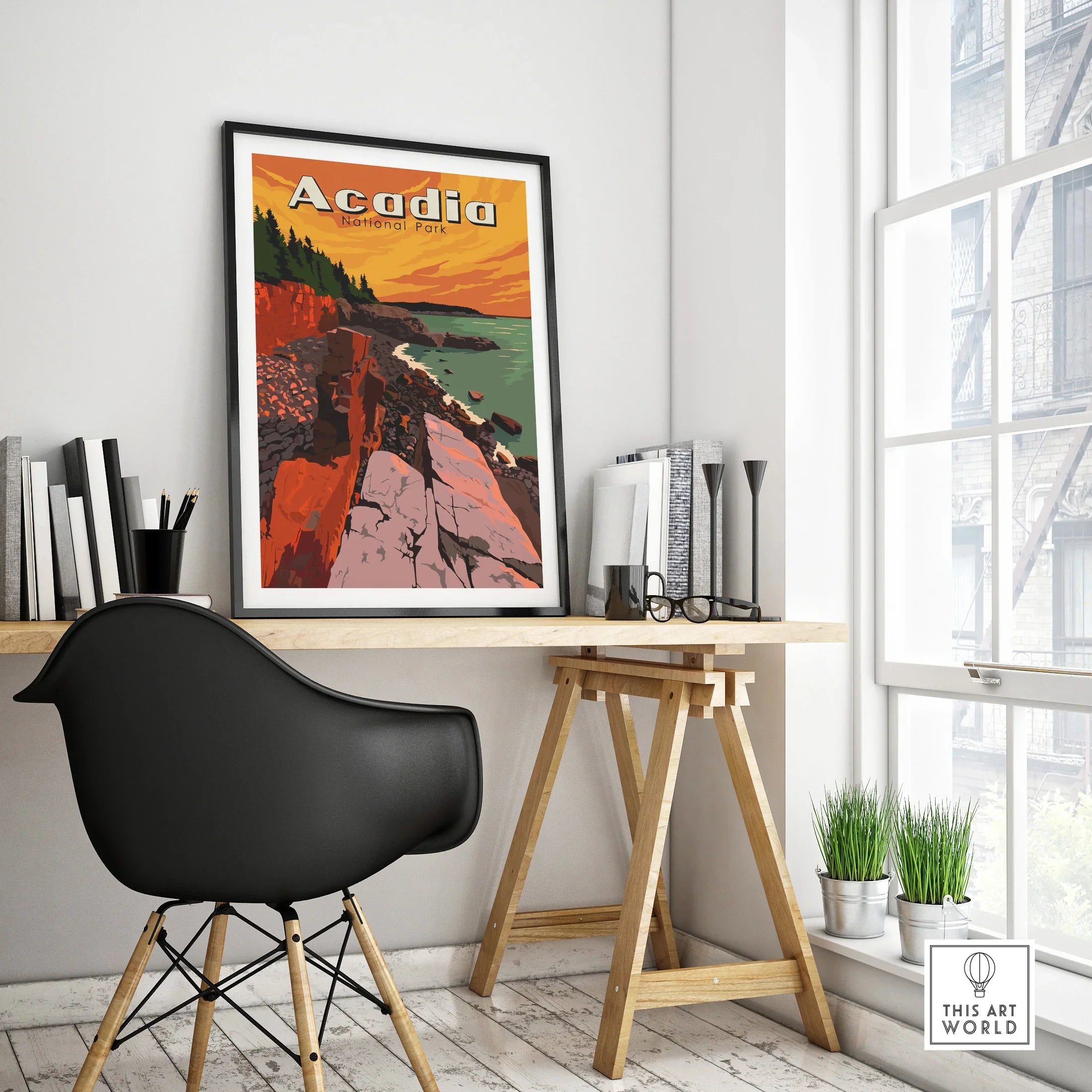 Framed Acadia National Park travel poster on a modern office desk by a window