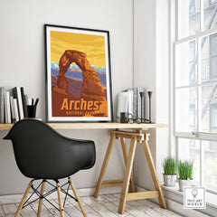 Framed Arches National Park travel poster on a modern office desk with black chair