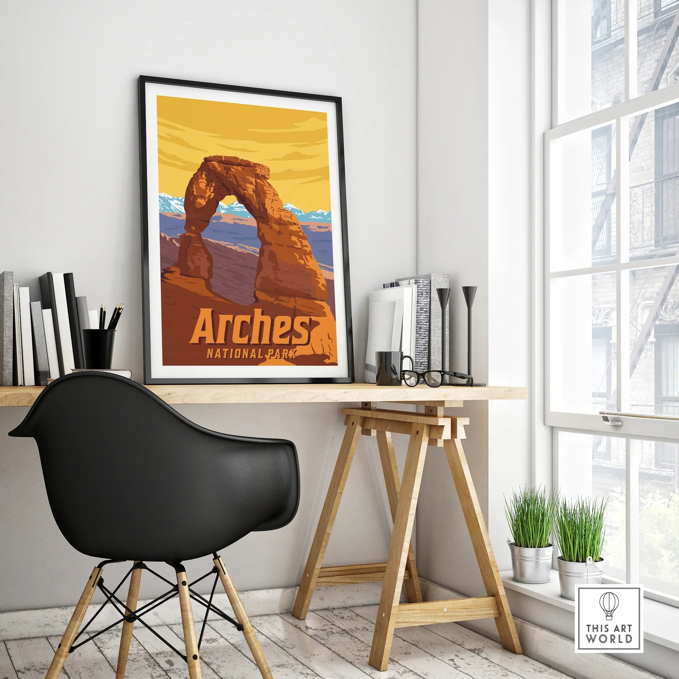 Framed Arches National Park travel poster on a modern office desk with black chair