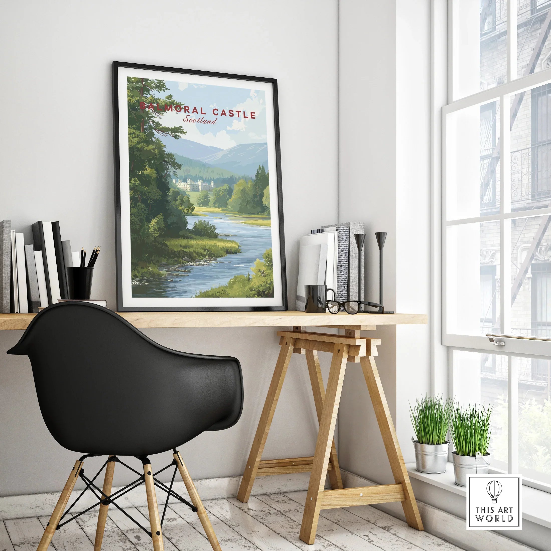 Framed Balmoral Castle travel poster on modern office desk by window with black chair