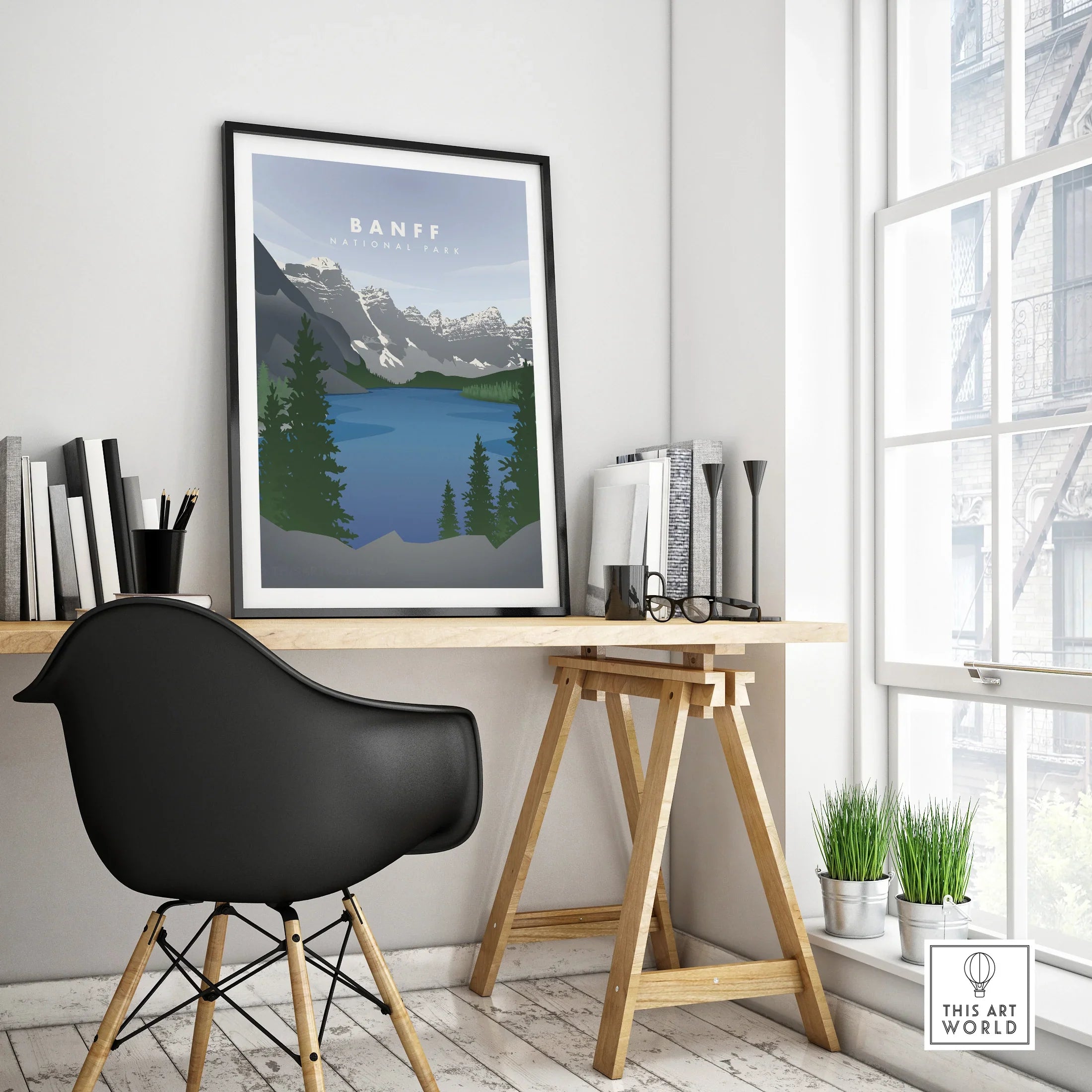 Banff National Park travel poster in black frame on modern office desk, minimalist decor