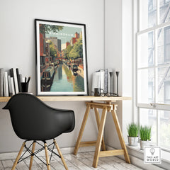 Framed Birmingham England travel poster on modern office desk with black chair