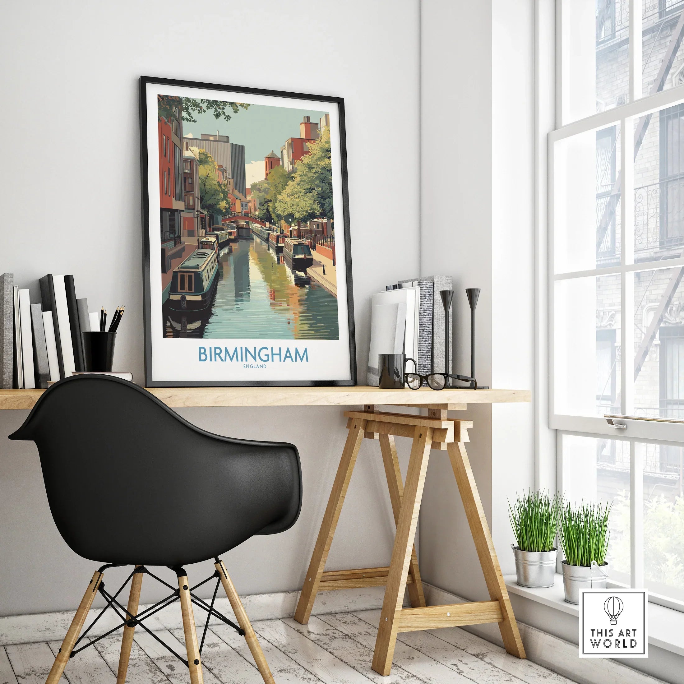 Framed Birmingham city canal travel poster on modern office desk with black chair