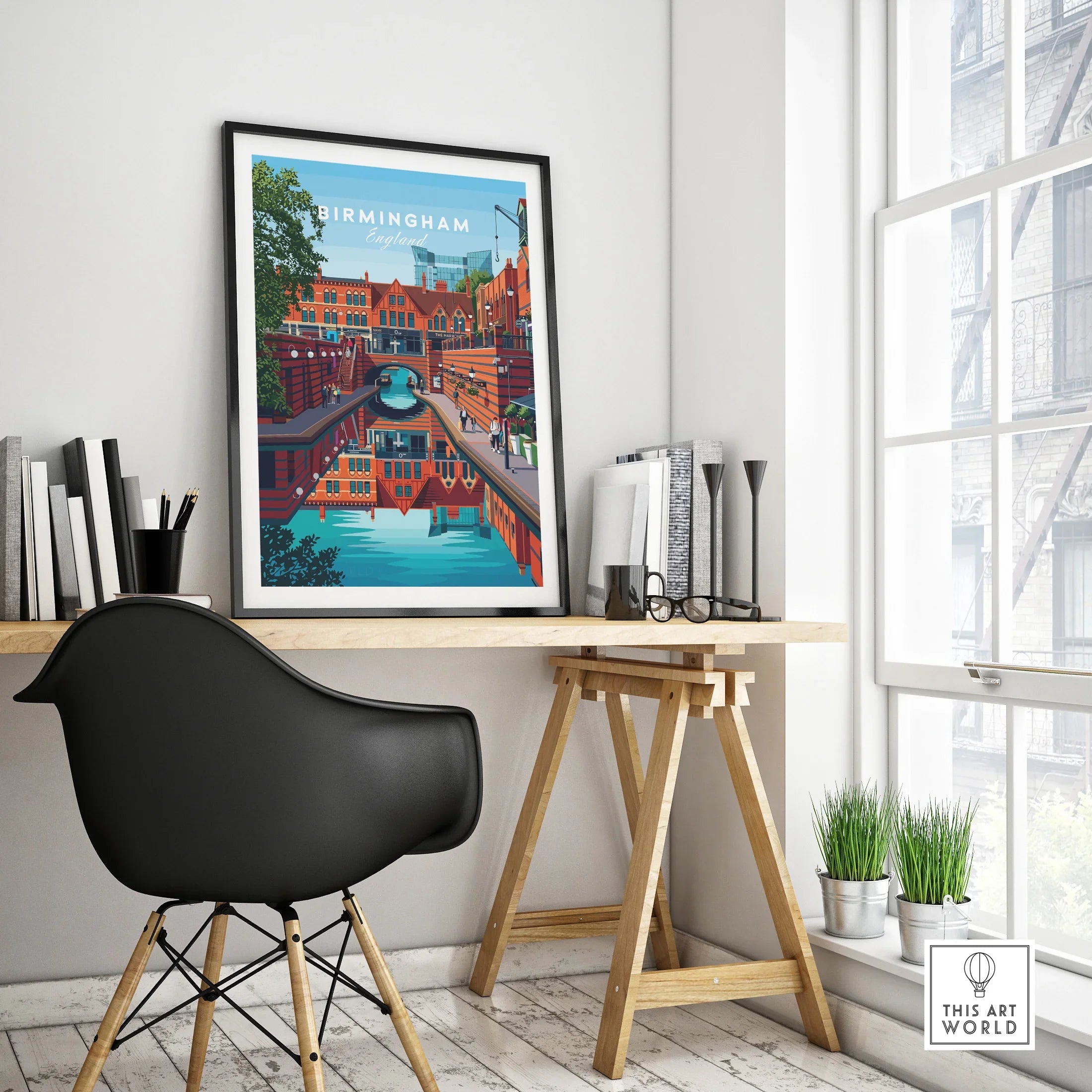 Framed Birmingham city skyline art print on modern office desk by a window
