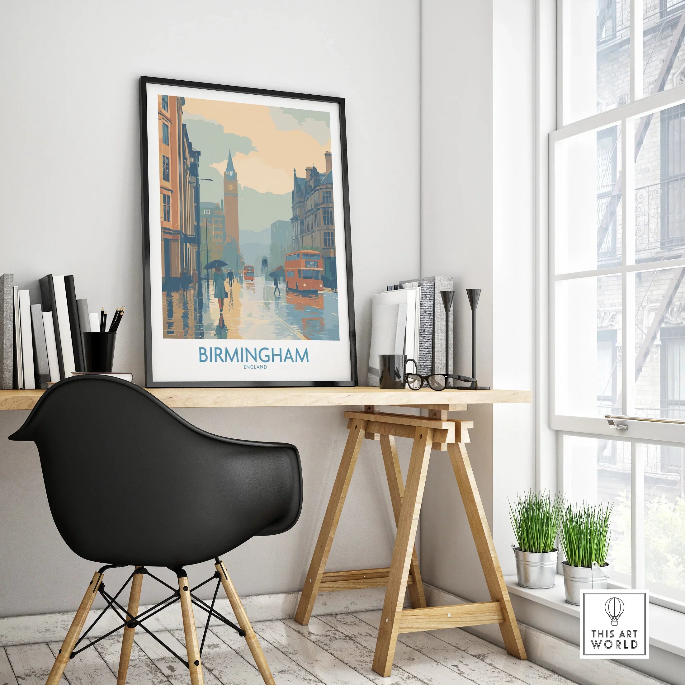 Framed Birmingham travel poster on modern office desk with cityscape design