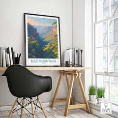 Framed Blue Mountains Australia travel poster on modern office desk by window