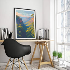 Framed Blue Mountains travel poster on modern office desk, natural light, decor accents