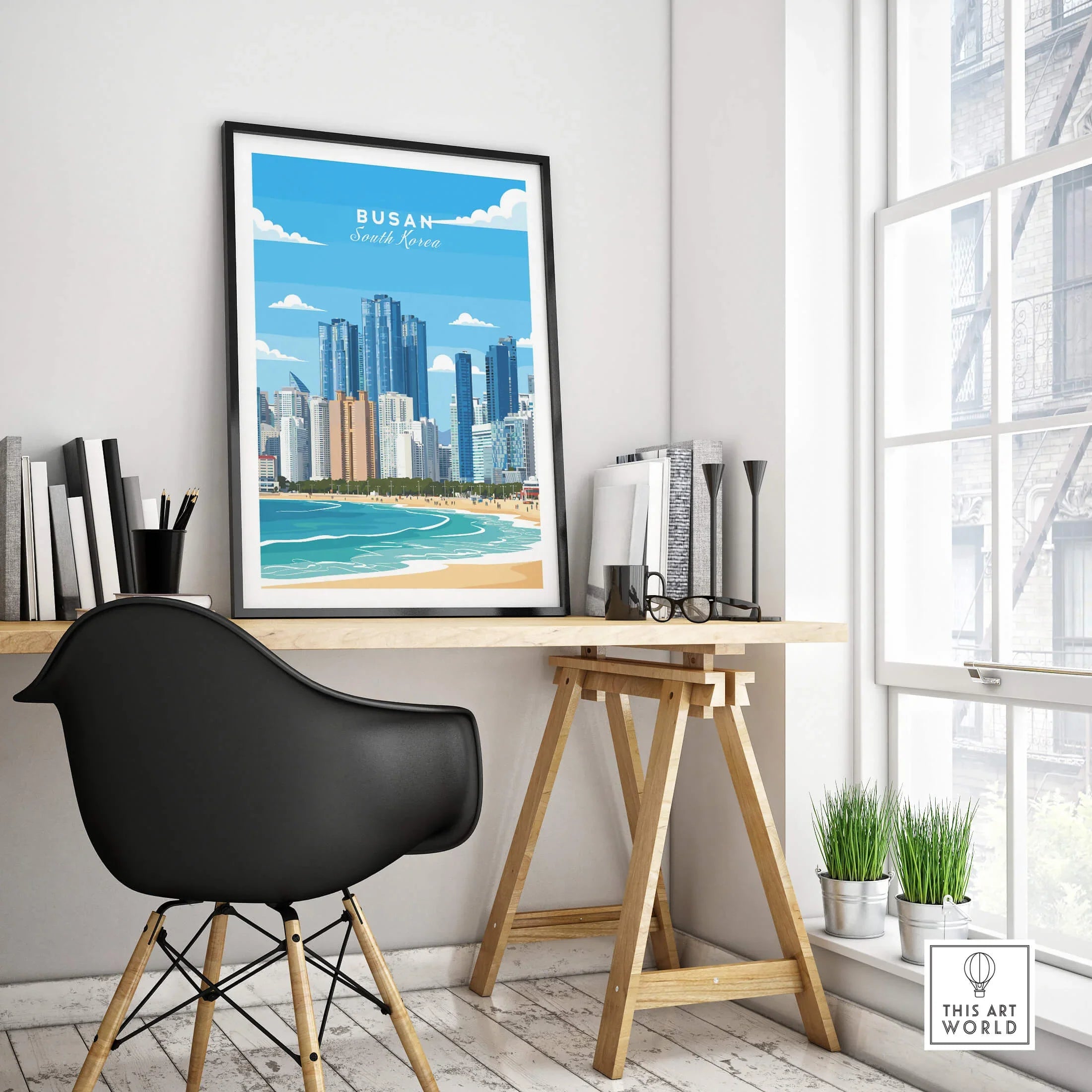 Framed Busan South Korea travel poster on modern office desk with city skyline art