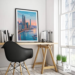 Framed Busan South Korea skyline travel poster on modern office desk by window