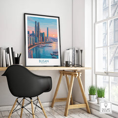Framed Busan city skyline travel poster on modern office desk by window