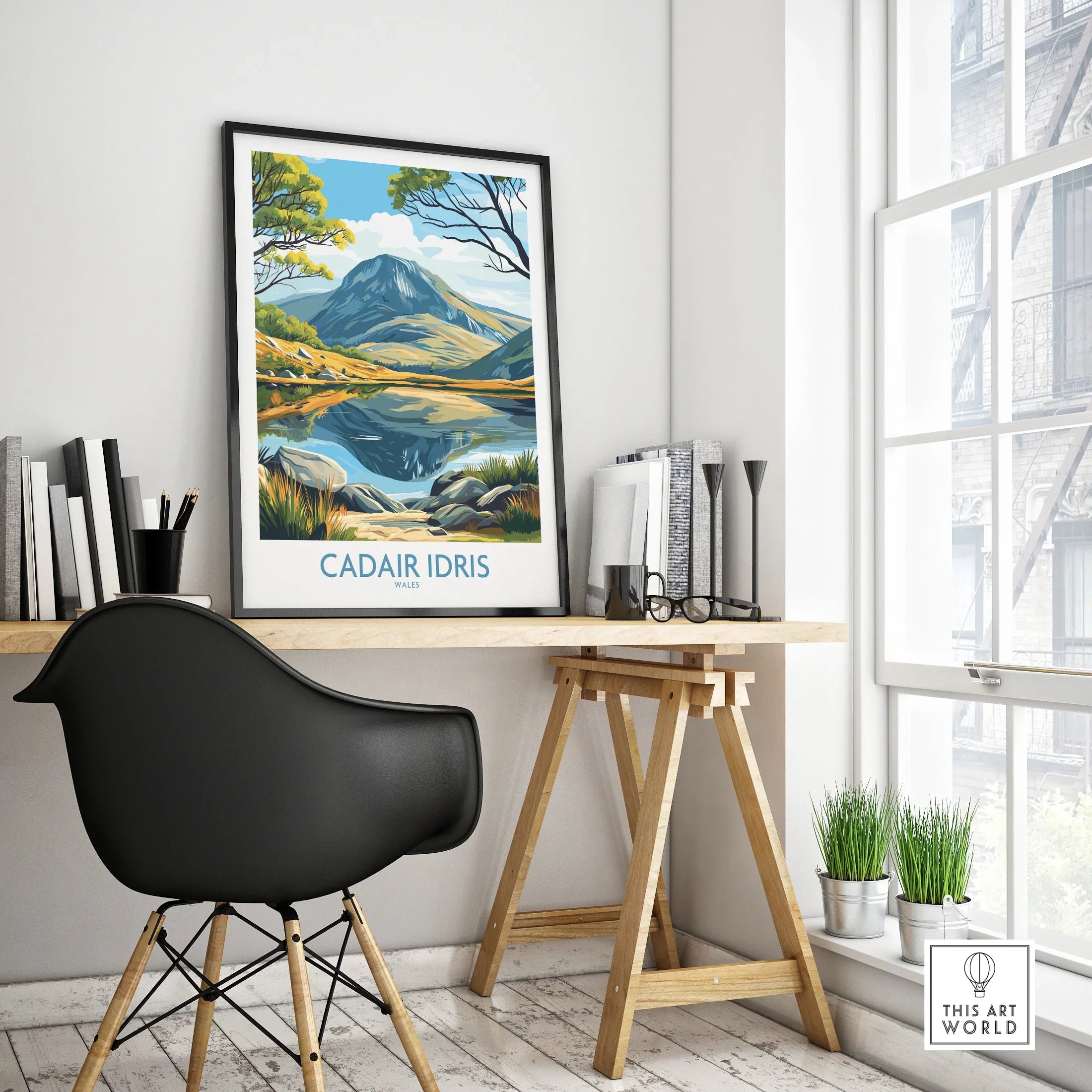 Framed Cadair Idris travel poster on modern office desk in bright minimalist room