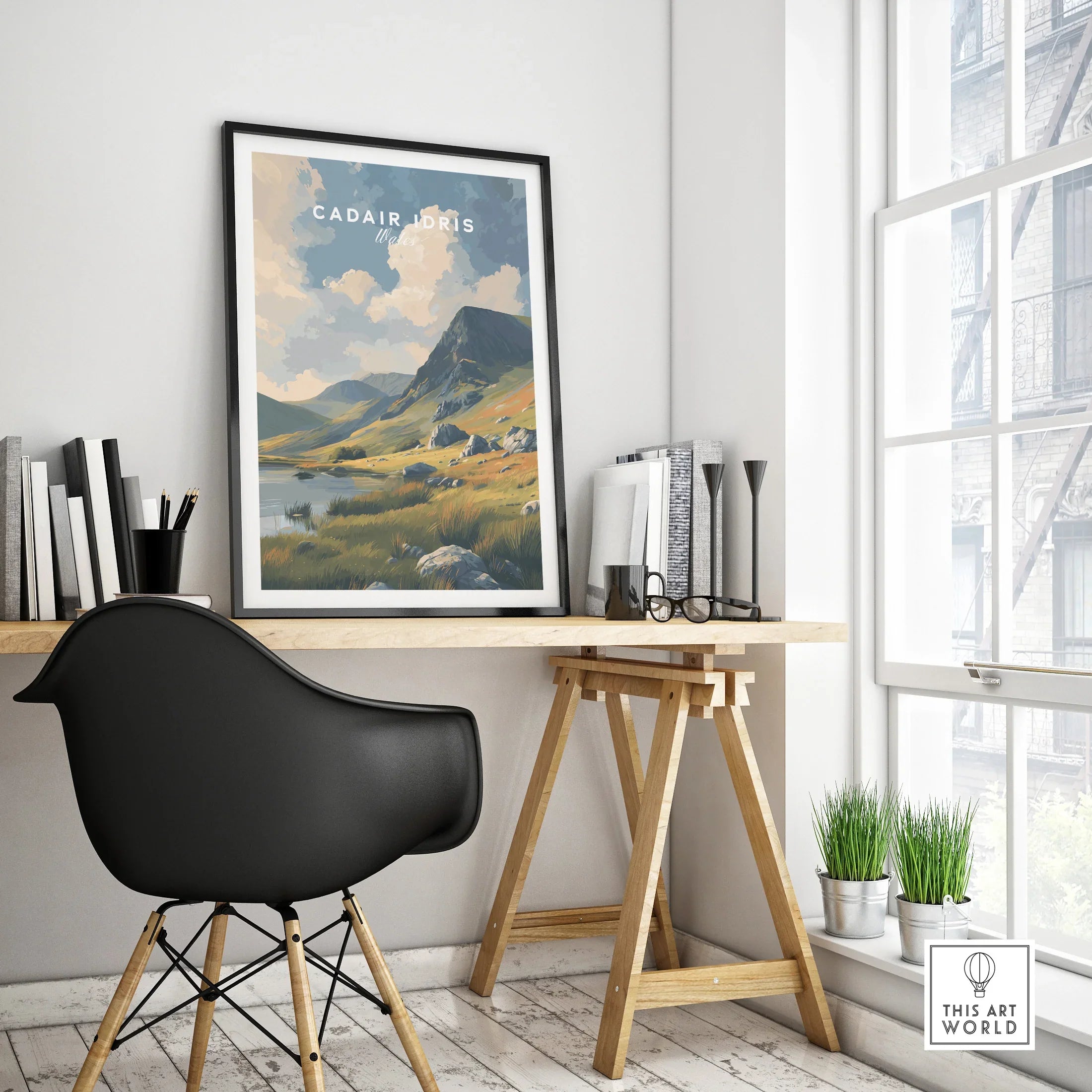 Framed Cadair Idris travel poster on modern home office desk by large window